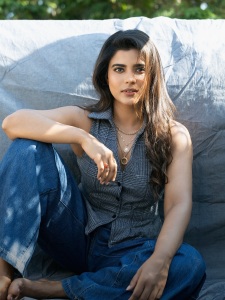 aishwarya-rajesh-in-Tailored-sleeveless-vest-top-paired-casually-with-wide-leg-blue-denim-jeans