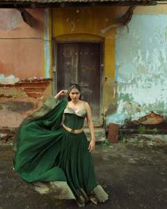 anarkali-marikar-in-structured-olive-green-corset-top-with-thin-straps-and-cupped-satin-detailing-at-the-bust-paired-with-dark-green-flared-skirt