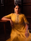 anarkali-marikar-in-A-bright-mustard-yellow-silk-or-chanderi-tunic-dress-featuring-a-round-neckline-half-length-sleeves-and-a-flares-out-into-a-flowing-skirt-002