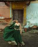 anarkali-marikar-in-structured-olive-green-corset-top-with-thin-straps-and-cupped-satin-detailing-at-the-bust-paired-with-dark-green-flared-skirt