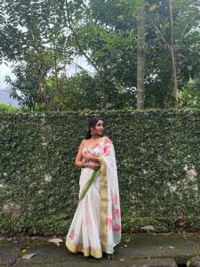 anikha-surendran-in-onam-set-saree-flower-design-photos-005