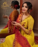 anikha-surendran-in-yellow-churidar-with-red-shawl-photos