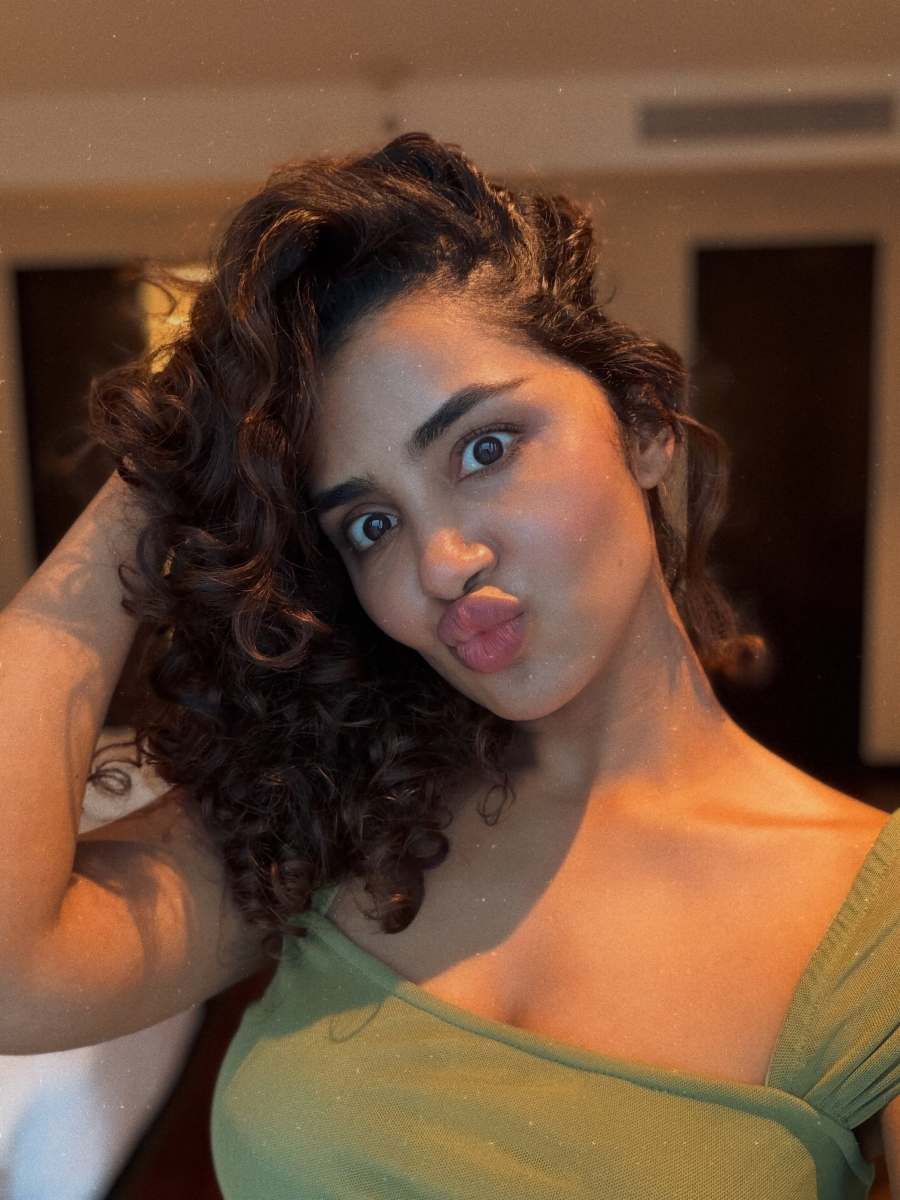 anupama-parameswaran-in-Olive-green-sleeveless-fitted-crop-top-with-Light-wash-denim-jeans-Features-standard-belt-loops-silver-button-or-rivet-hardware-style-photos-006