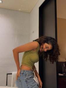 anupama-parameswaran-in-Olive-green-sleeveless-fitted-crop-top-with-Light-wash-denim-jeans-Features-standard-belt-loops-silver-button-or-rivet-hardware-style-photos-003