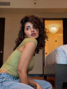 anupama-parameswaran-in-Olive-green-sleeveless-fitted-crop-top-with-Light-wash-denim-jeans-Features-standard-belt-loops-silver-button-or-rivet-hardware-style-photos-005
