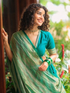 anupama-parameswaran-in-teal-blue-green-long-fitted-top-blouse-V-neckline-and-elbow-length-sleeves-with-patterned-cuffs-Lehenga-Set-photos