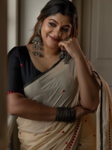 aparna-balamurali-in-classic-off-white-traditional-saree-embellished-with-delicate-red-polka-dot-motifs-and-a-contrasting-black-border-photos-003