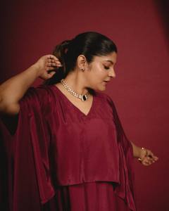 aparna-balamurali-in-deep-maroon-cape-style-gown-design-photos