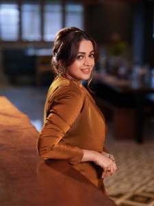 bhavana-actress-in-rich-mustard-brown-symmetrical-tulip-style-draped-dhoti-skirt-dress-photos-012
