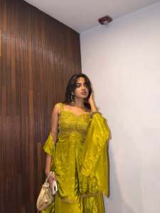 devika-sanjay-in-Sleeveless-sweetheart-neckline-tunic-in-a-vibrant-olive-green-kurti-with-Matching-flared-sharara-pants-in-a-satin-finish-fabric-photos