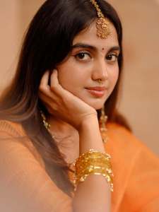devika-sanjay-in-twirling-vivid-marigold-orange-lehenga-skirt-paired-with-a-matching-sheer-organza-dupatta-bordered-with-delicate-gold-lace-photos-003