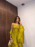 devika-sanjay-in-Sleeveless-sweetheart-neckline-tunic-in-a-vibrant-olive-green-kurti-with-Matching-flared-sharara-pants-in-a-satin-finish-fabric-photos