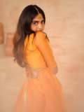 devika-sanjay-in-twirling-vivid-marigold-orange-lehenga-skirt-paired-with-a-matching-sheer-organza-dupatta-bordered-with-delicate-gold-lace-photos-001