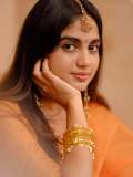 devika-sanjay-in-twirling-vivid-marigold-orange-lehenga-skirt-paired-with-a-matching-sheer-organza-dupatta-bordered-with-delicate-gold-lace-photos-003