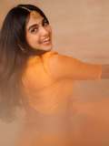 devika-sanjay-in-twirling-vivid-marigold-orange-lehenga-skirt-paired-with-a-matching-sheer-organza-dupatta-bordered-with-delicate-gold-lace-photos