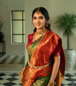 gayathri-suresh-in-dual-toned-pure-silk-Kanchipuram-saree-matching-crimson-red-silk-blouse-with-gold-zari-floral-motif-embroidery