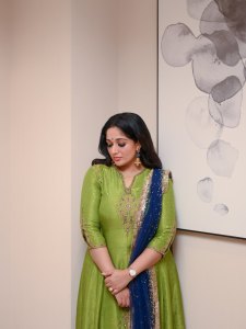 kavya-madhavan-in-Soft-wavy-hair-styled-open-paired-with-dangling-ethnic-earrings-and-a-small-blue-bindi-on-her-forehead-photos