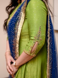 kavya-madhavan-in-churidar-sleeves-featuring-a-stylish-keyhole-slit-cut-at-the-hem-bordered-by-intricate-gold-zari-beadwork-and-dark-sequin-floral-embroidery-design