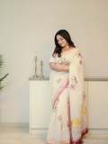 kavya-madhavan-in-Off-white-raditional-Kerala-inspired-modern-Saree-hand-embroidered-Matching-cream-colored-elbow-length-blouse-