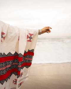 manjima-mohan-in-A-clean-minimal-all-white-solid-co-ord-set-featuring-a-long-sleeved-mid-length-tunic-kurta-with-matching-loose-fit-white-trousers-and-bold-red-and-black-shawl-001