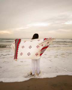 manjima-mohan-in-A-clean-minimal-all-white-solid-co-ord-set-featuring-a-long-sleeved-mid-length-tunic-kurta-with-matching-loose-fit-white-trousers-and-bold-red-and-black-shawl-003
