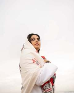manjima-mohan-in-A-clean-minimal-all-white-solid-co-ord-set-featuring-a-long-sleeved-mid-length-tunic-kurta-with-matching-loose-fit-white-trousers-and-bold-red-and-black-shawl-004