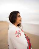 manjima-mohan-in-A-clean-minimal-all-white-solid-co-ord-set-featuring-a-long-sleeved-mid-length-tunic-kurta-with-matching-loose-fit-white-trousers-and-bold-red-and-black-shawl-002