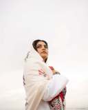 manjima-mohan-in-A-clean-minimal-all-white-solid-co-ord-set-featuring-a-long-sleeved-mid-length-tunic-kurta-with-matching-loose-fit-white-trousers-and-bold-red-and-black-shawl-004