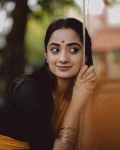namitha-pramod-in-black-saree-with-orange-border-dress-photos-003
