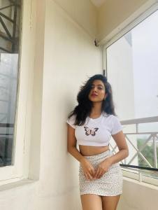 nandana-varma-white-outfit-with-white-cap-style-photos-002