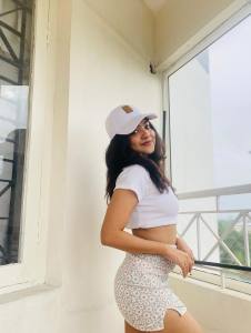 nandana-varma-white-outfit-with-white-cap-style-photos
