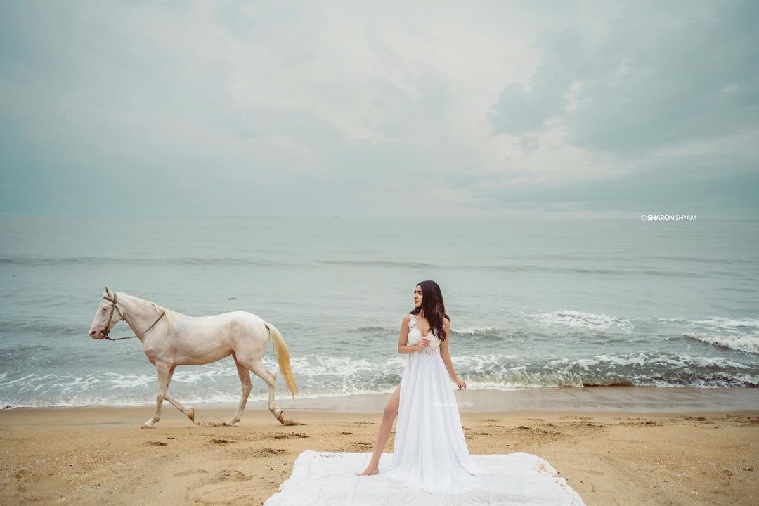 nandana-varma-latest-photos-in-white-colour-gown-with-horse-002