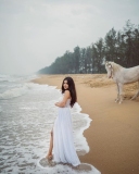 nandana-varma-latest-photos-in-white-colour-gown-with-horse-001
