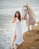 nandana-varma-latest-photos-in-white-colour-gown-with-horse-005