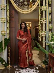 nikki-galrani-in-Tussar-silk-rust-red-with-warm-metallic-gold-saree-and-high-round-neckline-blouse-and-Styled-with-traditional-gold-jewelry-photos