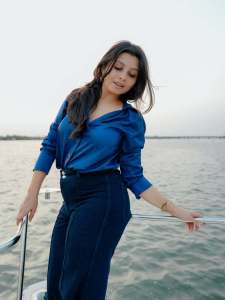 niranjana-anoop-in-vibrant-royal-blue-long-sleeved-button-down-shirt-and-High-waisted-wide-leg-dark-wash-jeans-photos