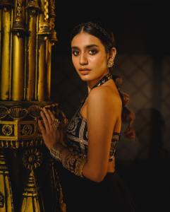 priya-varrier-latest-photos-in-criss-cross-crop-top-with-black-skirt-