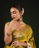 priya-varrier-in-mustard-yellow-hue-with-a-glossy-silk-saree-heavily-embellished-sleeveless-corset-or-bustier-style-blouse-ideas-photos-017