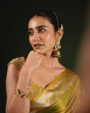 priya-varrier-in-mustard-yellow-hue-with-a-glossy-silk-saree-heavily-embellished-sleeveless-corset-or-bustier-style-blouse-ideas-photos