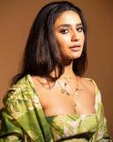 actress-priya-varrier-latest-pics-in-Green-Trench-Jacket-with-Short-Dress-004