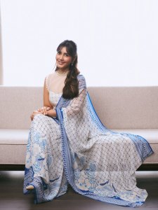 raashi-khanna-in-lightweight-sheer-white-fabric-saree-with-matching-sleeveless-blouse-with-a-sheer-mesh-illusion-neckline-photos-001