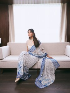 raashi-khanna-in-lightweight-sheer-white-fabric-saree-with-matching-sleeveless-blouse-with-a-sheer-mesh-illusion-neckline-photos-009