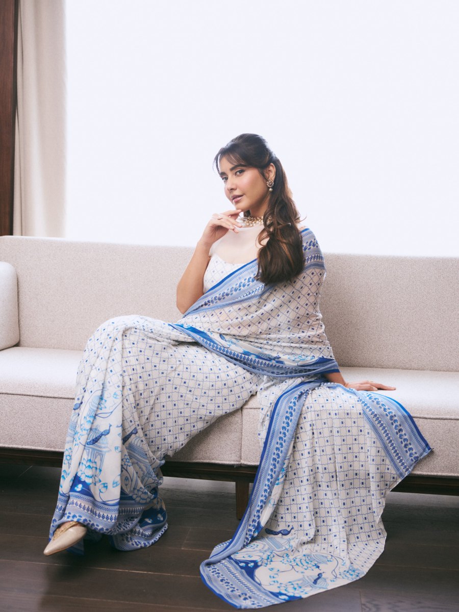 raashi-khanna-in-lightweight-sheer-white-fabric-saree-with-matching-sleeveless-blouse-with-a-sheer-mesh-illusion-neckline-photos-006