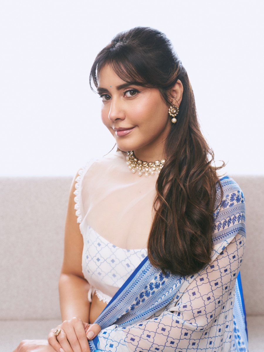 raashi-khanna-in-lightweight-sheer-white-fabric-saree-with-matching-sleeveless-blouse-with-a-sheer-mesh-illusion-neckline-photos-007