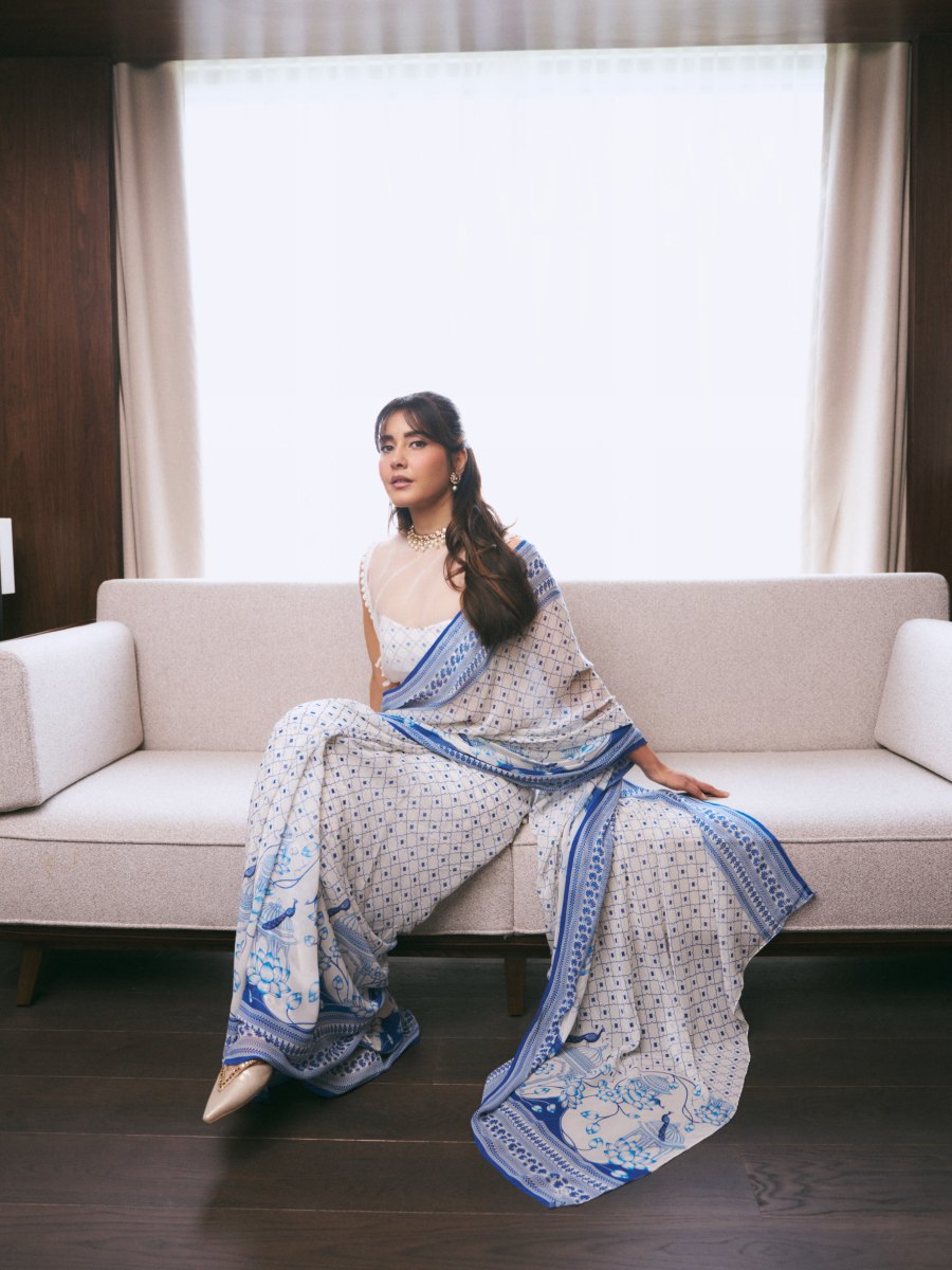 raashi-khanna-in-lightweight-sheer-white-fabric-saree-with-matching-sleeveless-blouse-with-a-sheer-mesh-illusion-neckline-photos-009