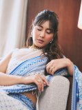 raashi-khanna-in-lightweight-sheer-white-fabric-saree-with-matching-sleeveless-blouse-with-a-sheer-mesh-illusion-neckline-photos-002