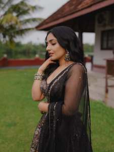 Actress-Rajisha-Vijayan-A-fitted-sleeveless-V-neck-crop-top-and-dark-Lehenga-photos