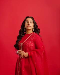 rajisha-vijayan-in-vibrant-red-full-sleeve-flared-Anarkali-styling-with-Traditional-gold-jhumkas-and-statement-rings-photos-001
