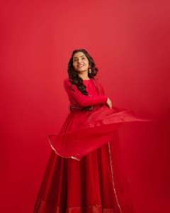 rajisha-vijayan-in-vibrant-red-full-sleeve-flared-Anarkali-styling-with-Traditional-gold-jhumkas-and-statement-rings-photos-002