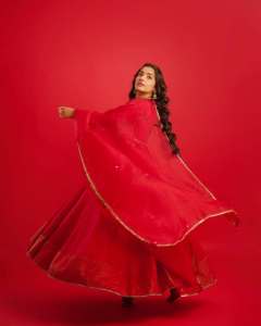 rajisha-vijayan-in-vibrant-red-full-sleeve-flared-Anarkali-styling-with-Traditional-gold-jhumkas-and-statement-rings-photos-004